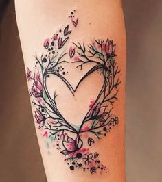 a heart shaped tattoo with flowers and leaves