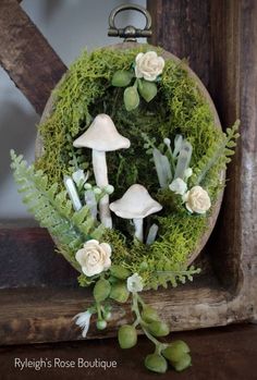 a wreath with flowers and mushrooms on it