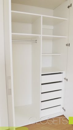 an empty white closet with drawers and shelves