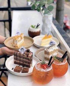 several desserts and drinks are sitting on the table