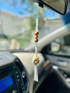 a car dashboard with beads hanging from it's dash board