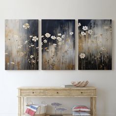 two paintings are hanging on the wall above a table