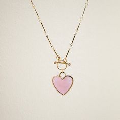 C R Y S T A L ∙ H E A R T ∙ N E C K L A C E A classic heart shaped rose quartz pendant on a gold plated brass toggle chain. Rose quartz is known for it's healing properties: Love, Self-Acceptance, and Emotional Healing. * Design: Crystal Heart Pendant - Toggle Chain Necklace * Material & Finish: Gold Plated Brass * Pendant: Rose Quartz Heart Pendant - Gold Plated Brass Frame * Pendant Size (Approx.): 20mm ** Your necklace may vary slightly due to the uniqueness of the stone B I R TH S T O N E ∙ Heart Shaped Jewelry With Toggle Clasp For Anniversary, Trendy Necklaces With Toggle Clasp For Valentine's Day, Valentine's Day Heart Pendant Jewelry With Toggle Clasp, Trendy Valentine's Day Necklace With Toggle Clasp, Valentine's Day Heart Pendant Toggle Necklace With Adjustable Chain, Heart Charm Toggle Necklace For Valentine's Day Gift, Elegant Heart Necklace With Toggle Clasp, Valentine's Day Toggle Necklace With Heart Charm As Gift, Valentine's Day Gift Toggle Necklace With Heart Charm