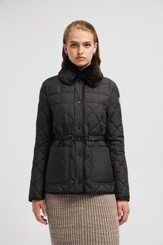 Designed for sophisticated women with a timeless style, the Cygne down jacket is easily layered over workwear and weekend leisure looks. Crafted from recycled polyester, the short puffer boasts geometric quilting and a nipped-in, belted silhouette. The lightweight style is finished with a detachable faux fur collar. Designer Quilted Winter Outerwear, Classic Black Outerwear With Faux Fur Trim, Classic Long Sleeve Fur Coat With Padded Collar, Luxury Long Sleeve Quilted Jacket For Winter, Luxury Long Sleeve Quilted Jacket For Fall, Designer Winter Quilted Jacket With Padded Collar, Designer Quilted Jacket With Padded Collar For Winter, Designer Long Sleeve Outerwear With Faux Fur Trim, Designer Black Outerwear With Faux Fur Trim