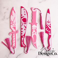 pink and white decorative knifes with tassels on them