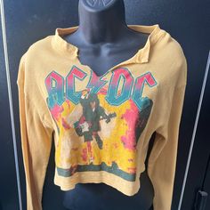 Yellow Acdc Crop Top. Perfect For Festival Wear And Everyday Wear. Fun And Versatile Looks Can Be Made With This Cute Top! New Never Worn Trendy Yellow Long Sleeve T-shirt, Trendy Long Sleeve Yellow T-shirt, Yellow Long Sleeve Top With Graphic Print, Trendy Yellow Long Sleeve Tops, Retro Mustard Long Sleeve Tops, Mustard Retro Long Sleeve Tops, Casual Yellow T-shirt For Fall, Mustard Long Sleeve Retro Top, Casual Yellow Tops For Fall