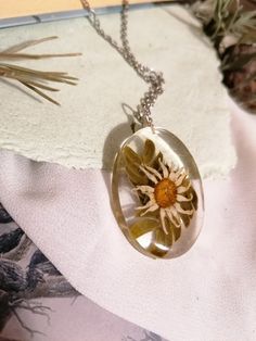 a necklace with a flower inside of it