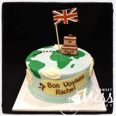 a cake with a flag and suitcase on it