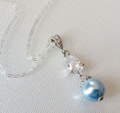 Light Blue Blush Blue Pearl Drop Silver Cubic Zirconia Wedding Bridal Pendant Necklace with .925 Sterling Silver Chain. PLEASE READ ITEM DESCRIPTION and SHOP POLICIES before placing your order, and contact me with any questions CHAIN is 20 inches (50.8cm) long. PENDANT is about 1.29 inch (3.3cm) long including bail. MATCHING EARRINGS: https://www.etsy.com/listing/529633883/blush-blue-pearl-earrings-light-blue?click_key=05ee615b36def4bf22e63d31c29c3cc1e7fccf02%3A529633883&click_sum=8b6b5e29&ref=s Elegant Light Blue Necklace For Wedding, Elegant Light Blue Wedding Necklaces, Elegant Light Blue Jewelry For Wedding, Elegant Blue Wedding Necklaces, Elegant Blue Wedding Necklace, Pink Pearl Wedding Jewelry, Jewellery Organization, Bridal Pendant Necklace, Blue Silver Weddings