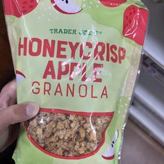 a hand holding a bag of honeycrisp apple granola