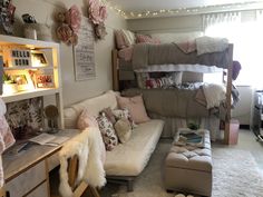 a room with bunk beds, couch and desk