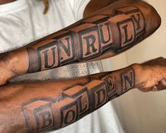 two men with tattoos on their arms that read unrulty and golden in large letters