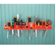 there are many different types of tools on the shelf in front of this wall rack