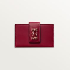 Cartier - Accordion card holder, C de Cartier - Wallet  - C de Cartier accordion card holder in cherry red calfskin. 4 credit card pockets and 1 insert between each pocket. 1 press stud. Interior: black lambskin, golden hot-stamped "Cartier" signature. Dimensions: height 65 mm x length 105 mm. Cartier Wallet, Trinity Bracelet, Trinity Necklace, Accordion Cards, Cartier Earrings, Cartier Necklace, Coin Holder, Cartier Ring, Love Bracelets