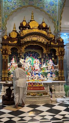 an old man standing in front of a shrine