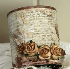 an old hat with roses on it sitting on top of a white doily covered table