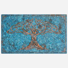 a blue and brown painting with an intricate tree on it's side, in the shape of a cross