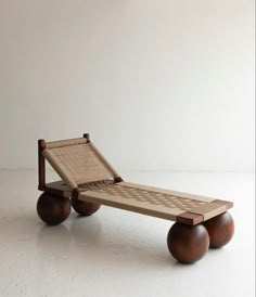 a wooden chaise lounger with wheels on the bottom and seat up to one side