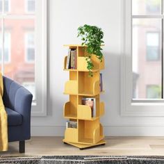 a living room with a blue chair and yellow bookshelf next to a window