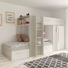 a white bunk bed sitting in a bedroom next to a book shelf and rug on top of a hard wood floor