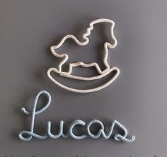 the word lucas is made out of rope and has a baby's head on it