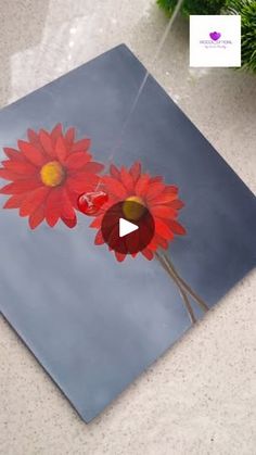 a painting of two red flowers on a blue background