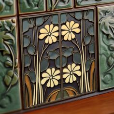 decorative tiles with flowers and vines on them