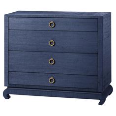 a blue dresser with three drawers and two gold knobs on the front, against a white background