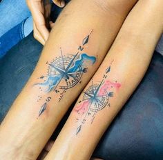 two people with tattoos on their legs, one has a compass and the other has an arrow