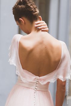 the back of a woman wearing a pink dress