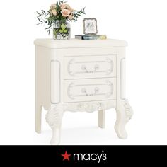 a white nightstand with flowers on top of it