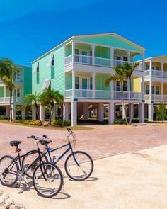 two bikes parked in front of multi - story buildings