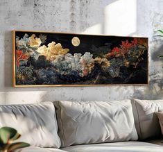 a painting hanging on the wall above a couch