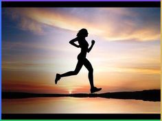 the silhouette of a woman running at sunset