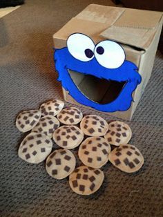 the cookie box has cookies in it and is next to an sesame character