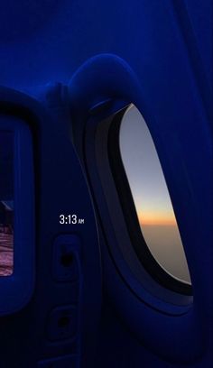 the view from inside an airplane window at sunset