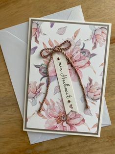 a handmade card with flowers on it and a ribbon tied around the edge that says, thank you