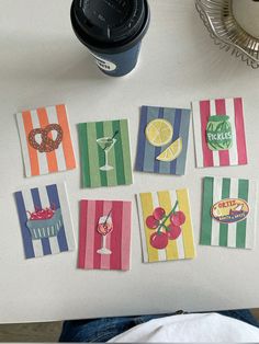 there are many cards on the table with drinks and donuts in them that have been cut into squares