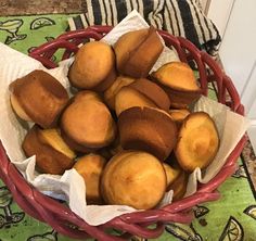 a basket filled with muffins sitting on top of a table