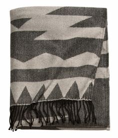 a black and white blanket with fringes on it