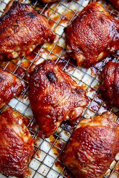 chicken wings covered in marinara sauce cooling on a wire rack, ready to be cooked