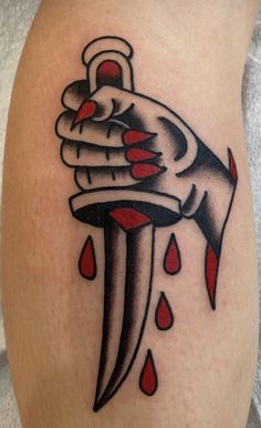 a tattoo with a knife and blood drops