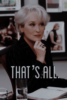 an older woman sitting at a desk in front of a book with the title that's all