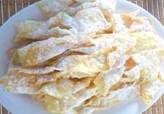 a white plate topped with lots of powdered sugar