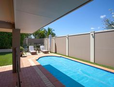 an empty swimming pool in the middle of a backyard