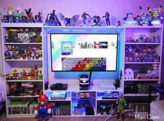 two children playing video games in front of a large screen tv on a book shelf