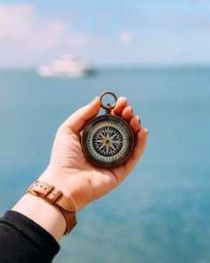 someone holding a compass in their hand with the text moving abroad what to expect when you're an expert