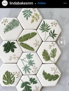 some green leaves and plants are arranged in hexagonal tiles