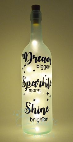 a light up bottle that says dream bigger, sparkle more shine brighter