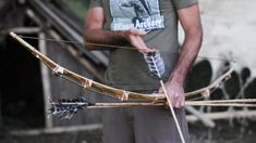 a man holding an arrow with two arrows